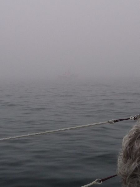 Fishing boat in fog.
